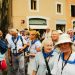A tour group walking along a narrow European street