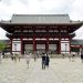 Visitors walking toward a large temple gate in Japan